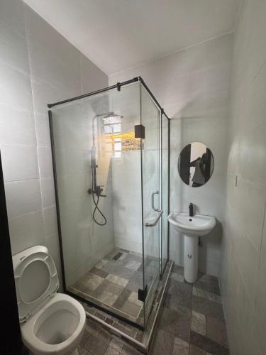 a bathroom with a shower and a toilet and a sink at 4bedroom Stunning Terrace Apartment In Orchid Lekki in Lekki