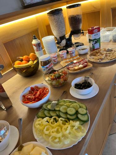 a counter with plates of food and bowls of vegetables at Penzión Patrik in Ždiar