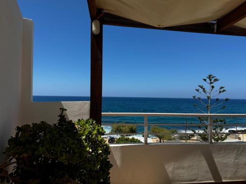 a view of the ocean from a room with a window at Sisi Blue Seafront Apt in Sissi