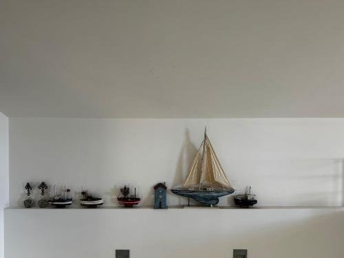 a shelf with a small model boat on it at Sisi Blue Seafront Apt in Sissi