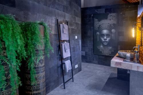 a bathroom with a sink and a green wall at Balidroomvilla Sanur - Full Serviced - Beachside in Sanur