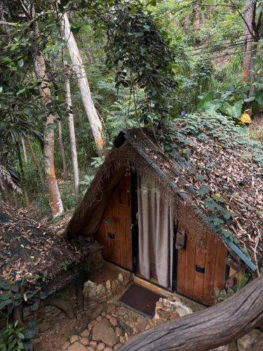a small house in the middle of a forest at Wild Heart Glamping in Ella