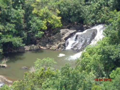 a waterfall in the middle of a river at The Kissing Mountains in Vagamon