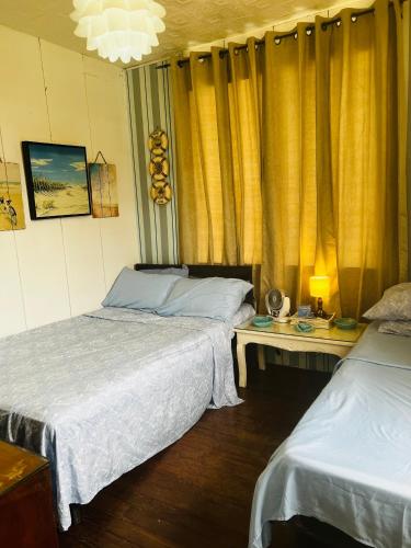 Ένα ή περισσότερα κρεβάτια σε δωμάτιο στο Anton & Isabel Charming Home in Bangued