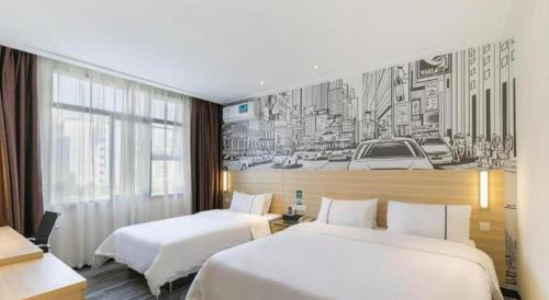 a hotel room with two beds and a drawing on the wall at City Comfort Inn Guangzhou Zengcheng Wanda Plaza Metro Station in Zengcheng