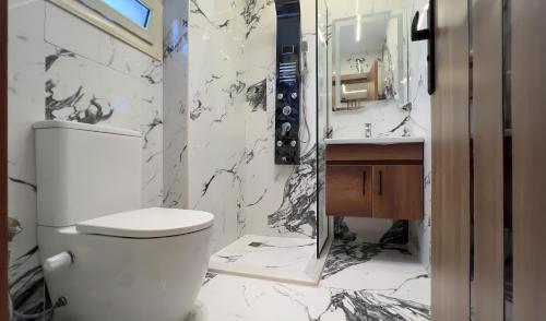 a bathroom with a toilet and a sink at Pyramids moon Tower in Cairo