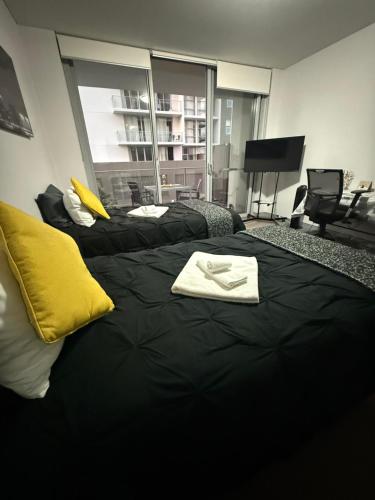 a room with two beds with towels on them at Cozy Private Room With Bathroom Right In Wollongong in Wollongong