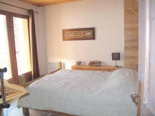 a bedroom with a bed and a desk with a lamp at Chalet des Trappeurs Coeur Vanoise 15 persons in Champagny-en-Vanoise