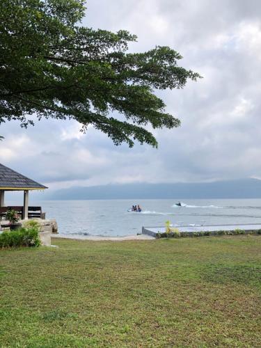 a view of the beach with people in the water at Hariara Guest House in Tuk Tuk