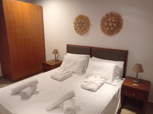a bedroom with a bed with towels on it at Tassos Holiday home in Archangelos