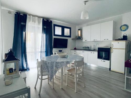 a kitchen with a table and chairs in a room at Agape in Policoro