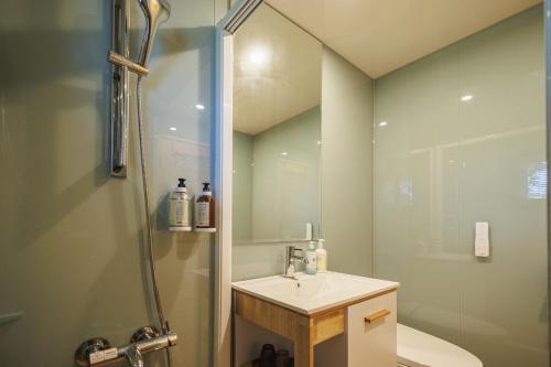 a bathroom with a sink and a shower at Chill hill cottage in Taiping