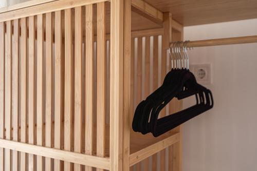 a wooden staircase with a black glove hanging from a rail at Koula's Aegina in Perdhika