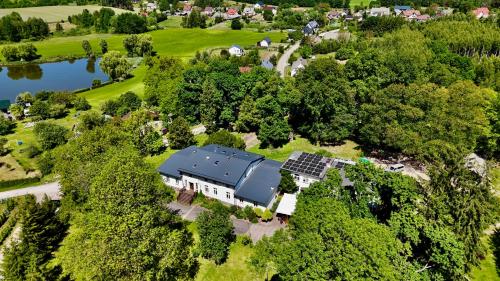 an aerial view of a house with solar panels on it at Domki Wierzchy in Wierzchy