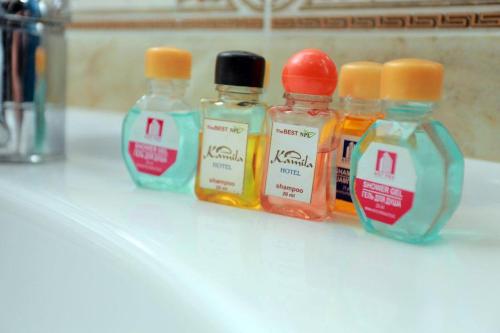 a group of four bottles of liquids sitting on a counter at Kamila & Terrace Boutique Hotel in Samarkand