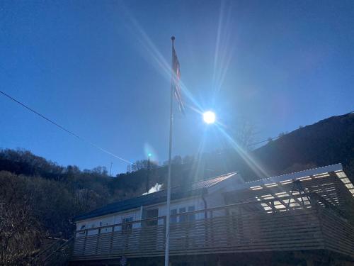 a building with a light on top of it at Koselig hytte nær sandstrand in Langenes
