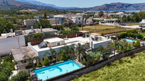 an aerial view of a house with a swimming pool at Villa Olympia, 7 BR, for up to 22 persons, 400 meters from the long sandy beach in Kavros