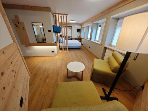 a small living room with a couch and a bed at Da Gigi Alpine Rooms in Crandola Valsassina