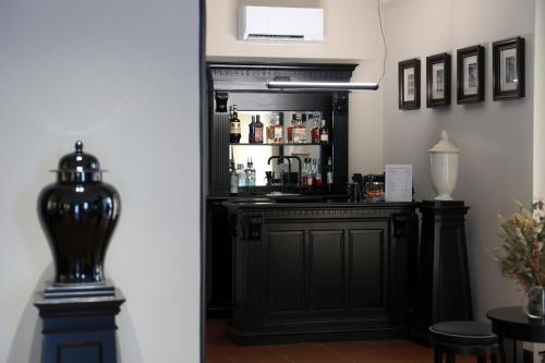a black bar in a room with a refrigerator at Santa Maria Foris in Ravenna
