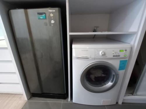 a refrigerator and a washing machine in a kitchen at AK Residence in Kuala Lumpur
