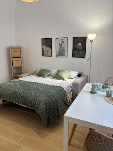 a bedroom with a bed and a table at Casa Vacanze La Donna di Cuori in Volterra