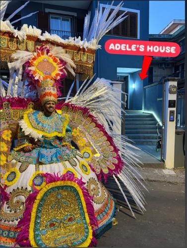 a man wearing an elaborate costume in front of a store at Adeles house in Misterbianco