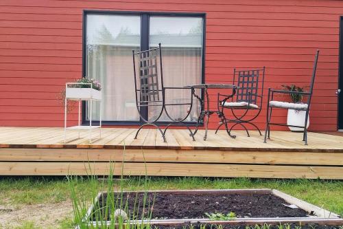 two chairs and a table on a wooden deck at Tiny house in Hailuoto in Hailuoto