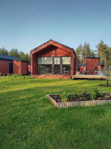 a house in a field with a green yard at Tiny house in Hailuoto in Hailuoto