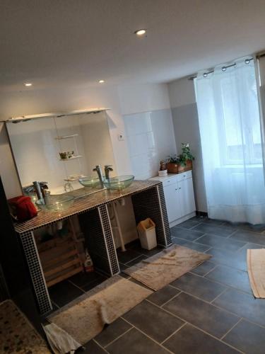 a bathroom with a sink and a mirror at Chic et relax familial in Montmarault