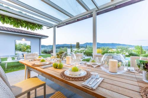 a wooden table with plates of food on it on a patio at The Secret Escape Villa in Sant' Alessio