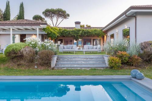 a house with a swimming pool in front of a house at The Secret Escape Villa in Sant' Alessio