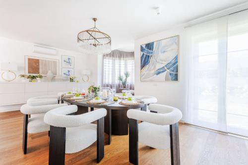 a kitchen and dining room with a table and chairs at The Secret Escape Villa in Sant' Alessio