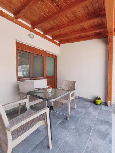a dining room with a table and chairs at Daniela Apartments in Nea Roda