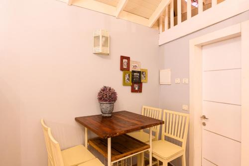 a small dining room with a wooden table and chairs at בקתות ילוז של רשת לב הגולן - 6 צימרים מקסימים עם בריכה משותפת ליד הכנרת in Yavneʼel