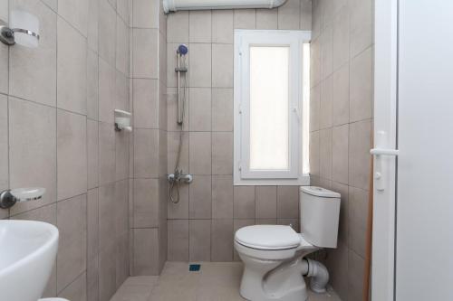 a bathroom with a toilet and a shower and a sink at Blue Life Hotel in Konak