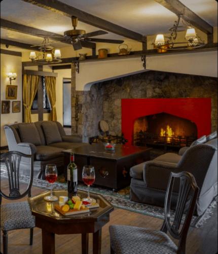 a living room with a couch and a fireplace at The Lakehouse Cameron Highlands in Ringlet