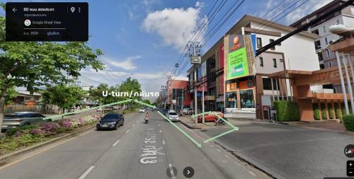 a view of a street with cars and a person riding a bike at HOMEY-Sleepy Don Mueang Airport Hostel in Bangkok