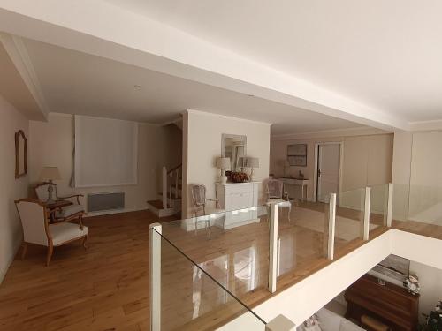 a living room with a glass staircase in a house at Le Charme des Bastides in Castelnau-de-Montmiral