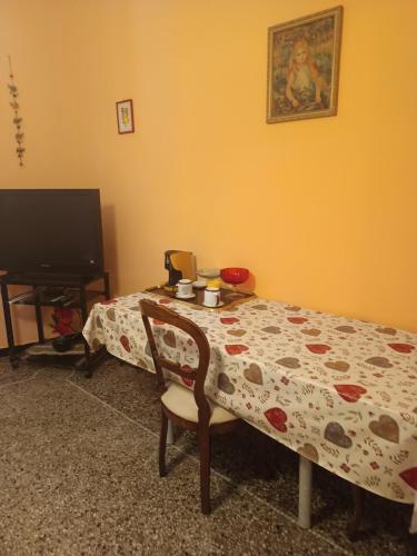 a bedroom with a bed and a table and a television at casa del sole in Genoa