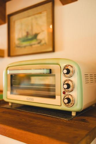 a toaster oven sitting on top of a table at Il Laghello Wood House in Framura