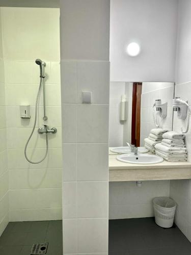 a bathroom with a shower and a sink at Hotel Mazury in Giżycko