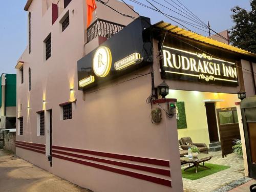 バラナシにあるRudraksh Innの側面に時計がある建物