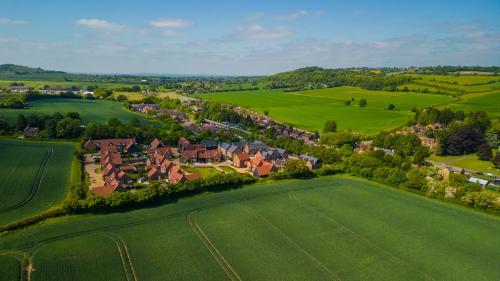 an aerial view of a village in a green field at Pass the Keys Bright Spacious Chilterns Hideaway in Saunderton
