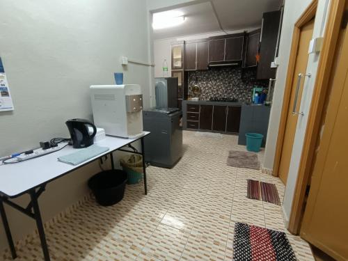 a kitchen with a white counter and a counter top at AA Homestay in Pengkalan Cepa