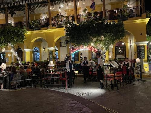 a group of people standing in a restaurant at night at Promo! 2BR-Pool-Views-King Bed-Walk 2 Beach-5 Star Area in Mazatlán