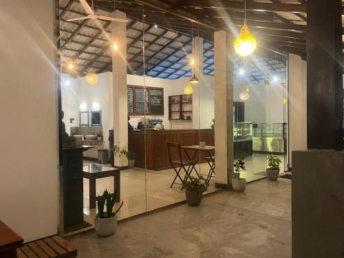 a large room with a kitchen and a dining room at Winland Coffee & Stay in Kitulgala