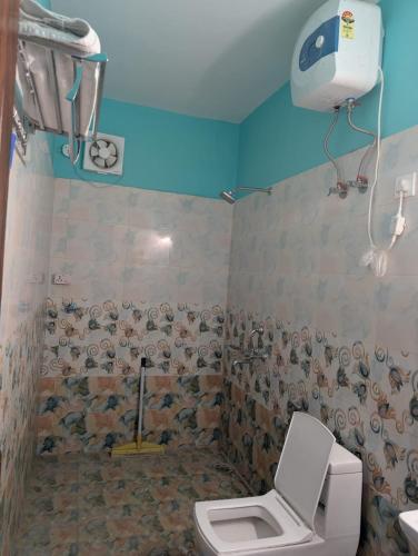 a bathroom with a toilet and a shower at Hilltop Heaven - One Bedroom Apartment in Mussoorie