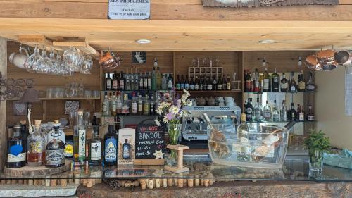 a bar with a lot of bottles of alcohol at Domaine de l'Adoux in Saint-Jean Montclar