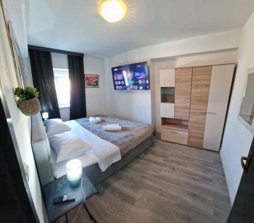 a bedroom with a large bed and a glass table at Island Chill Apartments ONE in Kali