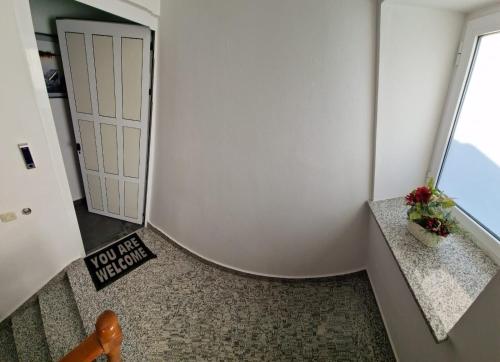 a room with a door with a sign on the floor at Island Chill Apartments ONE in Kali